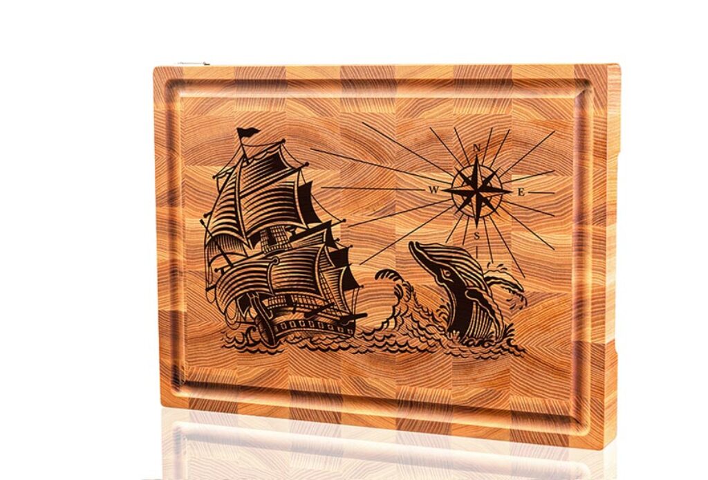 Sailing Serenity: Nautical Vessel and Leaping Whale Board