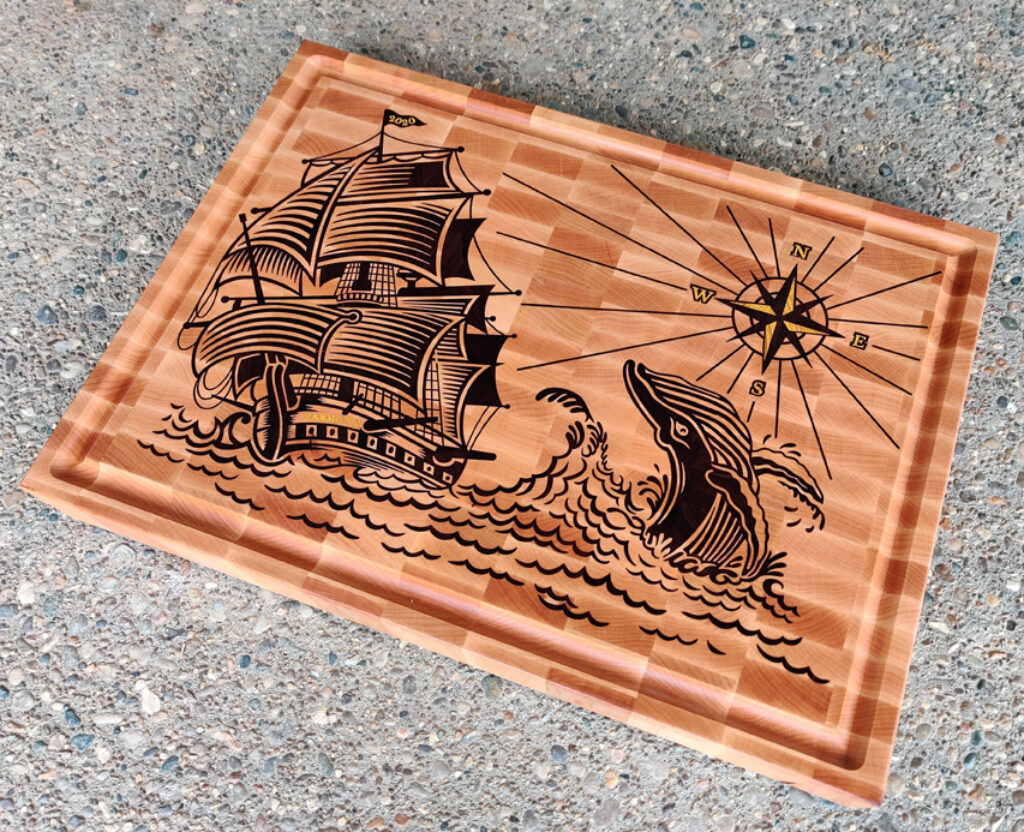 Sailing Serenity: Nautical Vessel and Leaping Whale Board