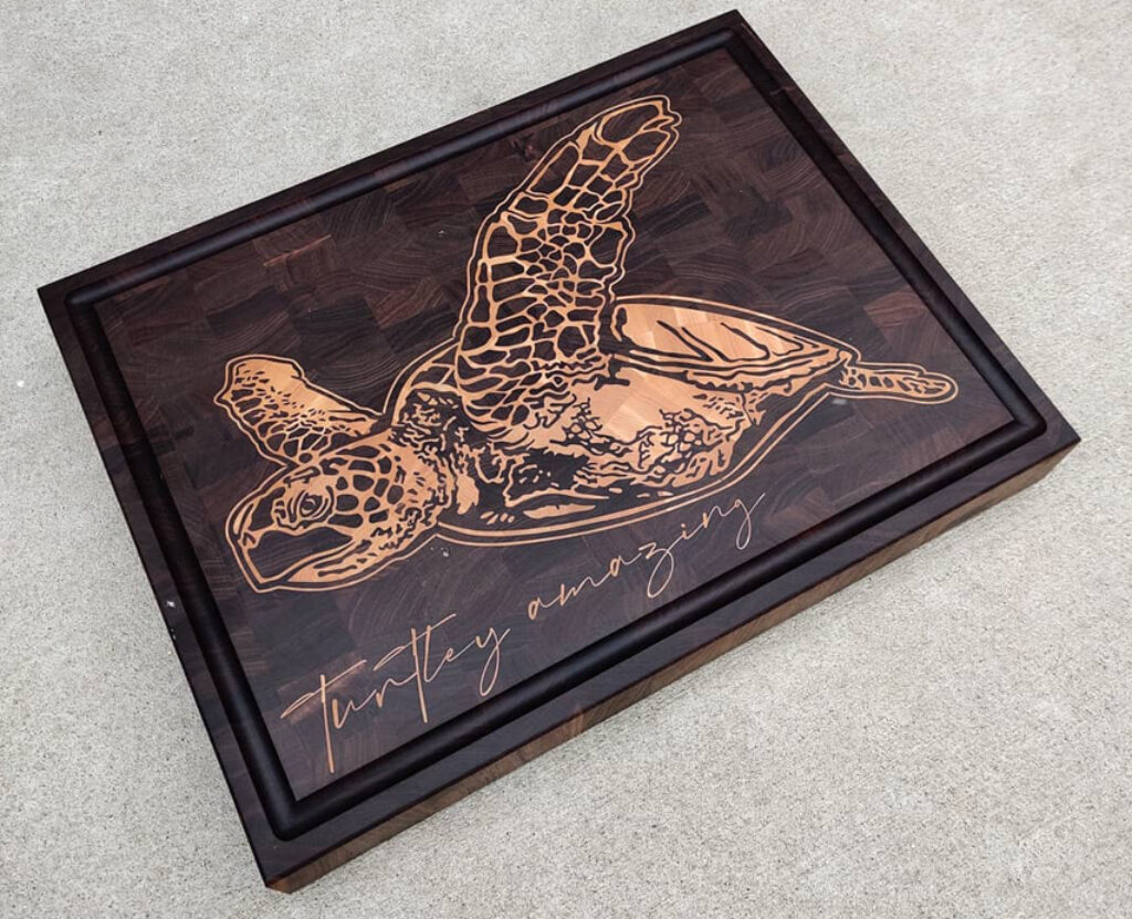 Sculpted Serenity: Wooden Inlay of a Swimming Turtle Cutting Boa