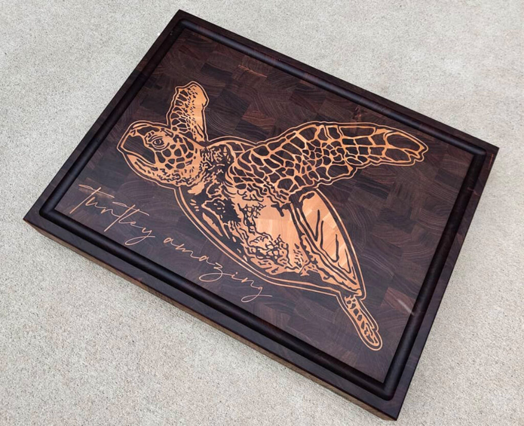 Sculpted Serenity: Wooden Inlay of a Swimming Turtle Cutting Boa