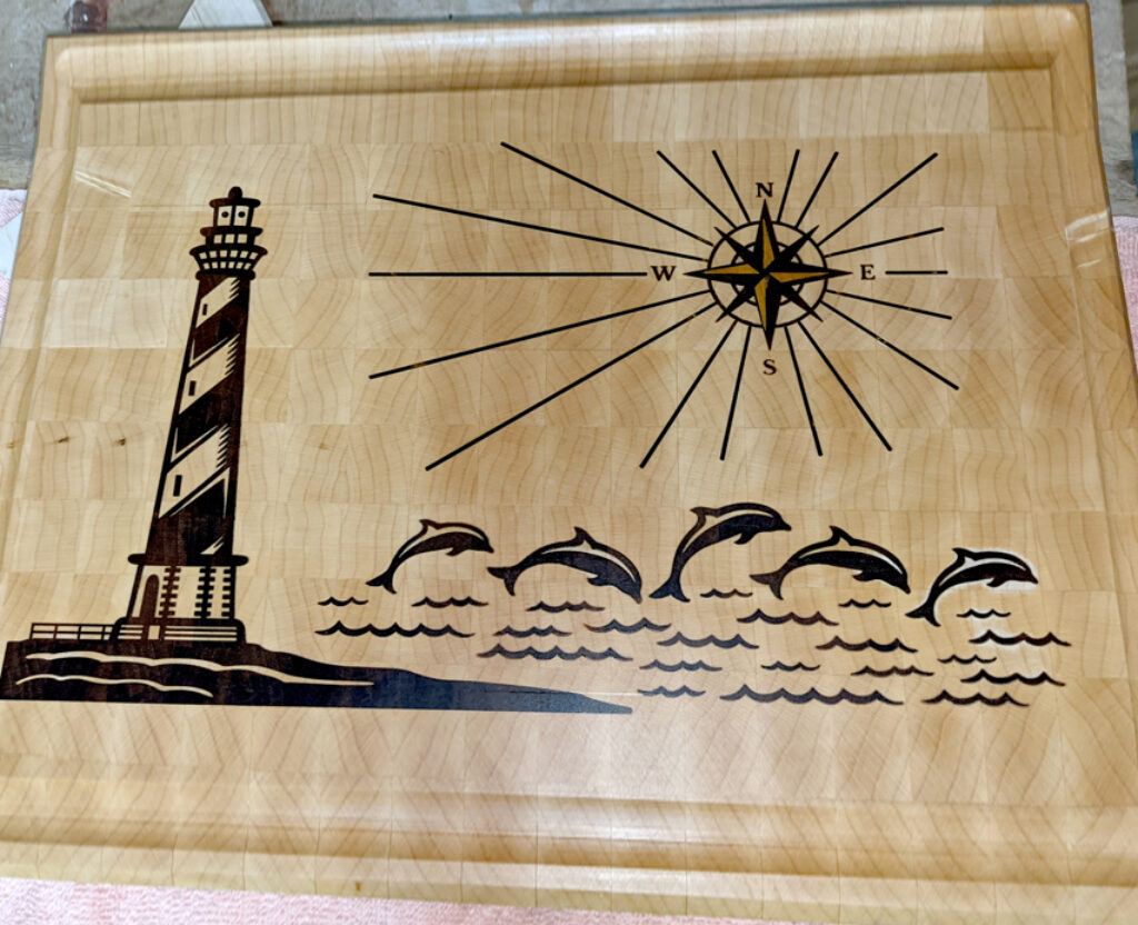 Coastal Harmony: Lighthouse and Dolphin Ensemble Board